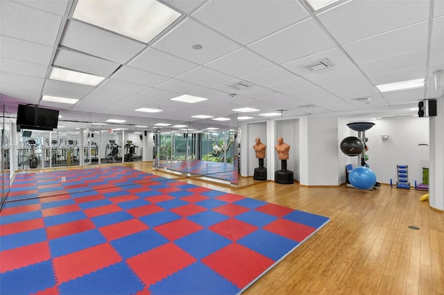 18671 Collins Ave Unit 3101, Sunny Isles Beach, FL 33160 - workout area featuring wood finished floors and a paneled ceiling