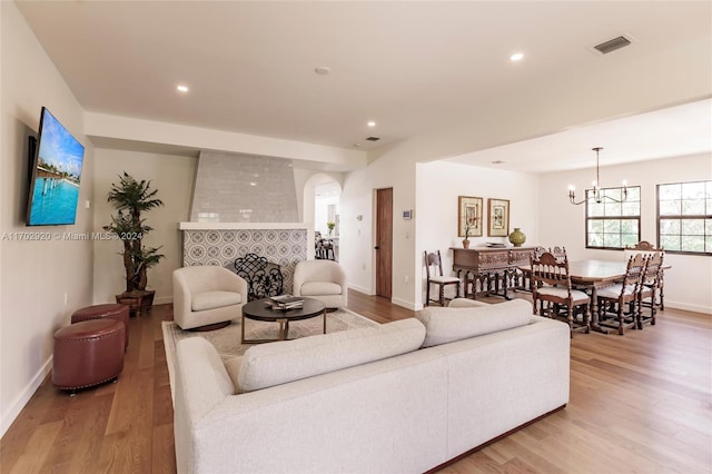 living room featuring an inviting chandelier and light hardwood / wood-style flooring