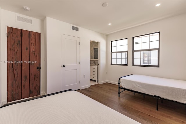 bedroom with dark wood-type flooring