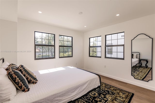 bedroom with hardwood / wood-style flooring