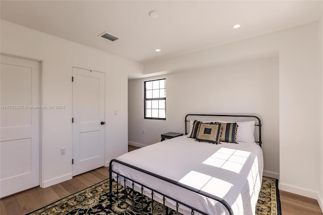 bedroom with hardwood / wood-style flooring