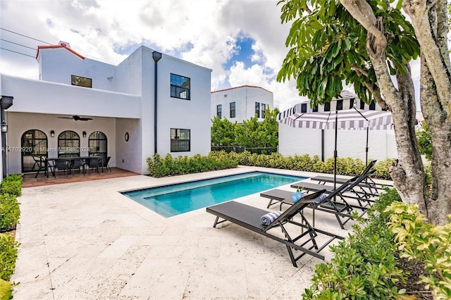 view of pool with ceiling fan and a patio