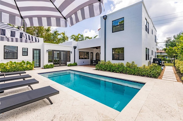 rear view of property featuring french doors and a patio