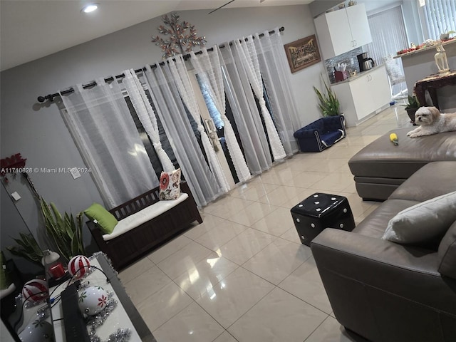 living room with light tile patterned floors and lofted ceiling