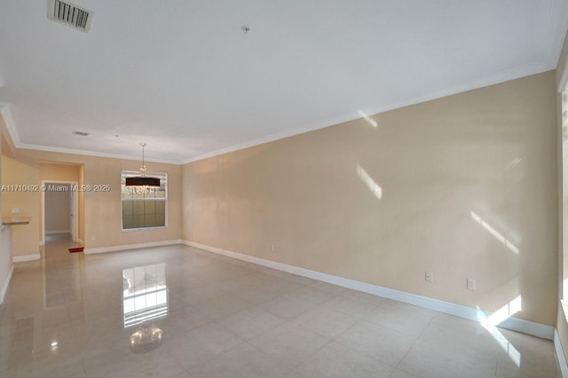tiled spare room with visible vents, baseboards, and ornamental molding