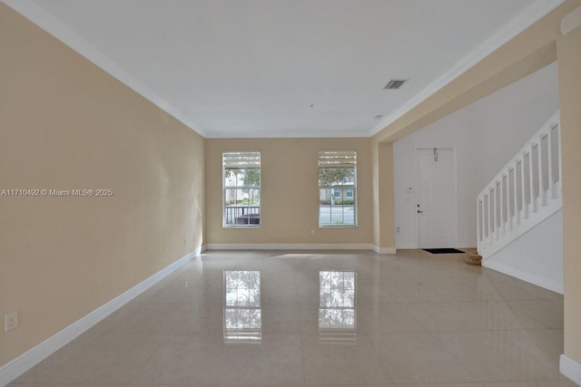 tiled empty room with baseboards, visible vents, stairs, and crown molding
