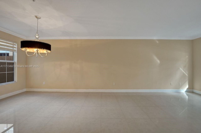 spare room with light tile patterned flooring, baseboards, and crown molding