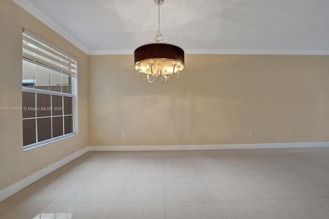 tiled empty room with ornamental molding and a chandelier