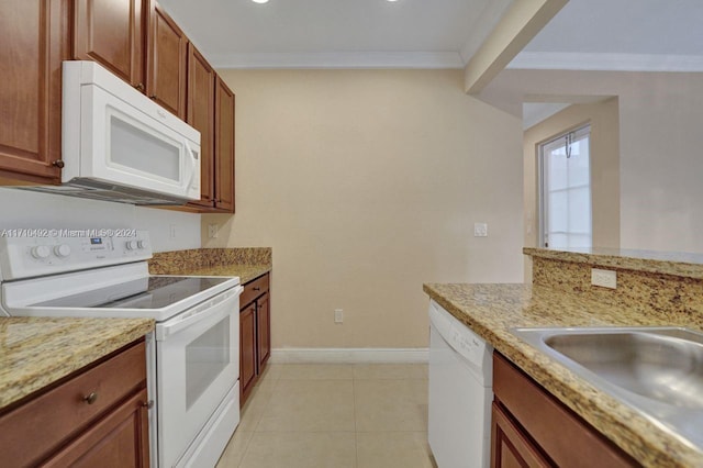 kitchen with white appliances, sink, ornamental molding, light tile patterned floors, and light stone counters