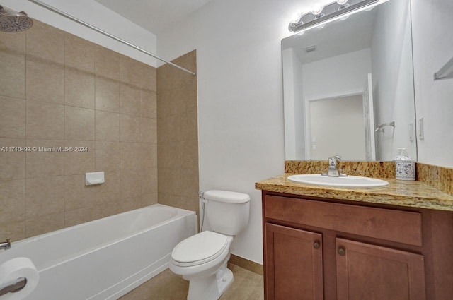 full bathroom with tile patterned floors, vanity, tiled shower / bath combo, and toilet