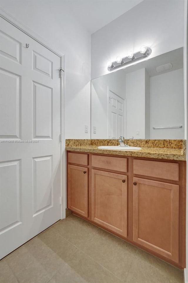 bathroom with tile patterned flooring and vanity