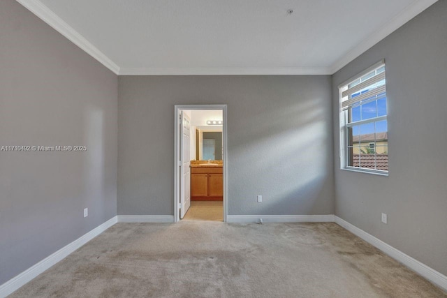 unfurnished room with light colored carpet, baseboards, and crown molding