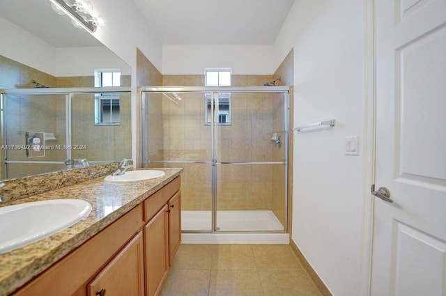 bathroom featuring tile patterned flooring, vanity, and an enclosed shower