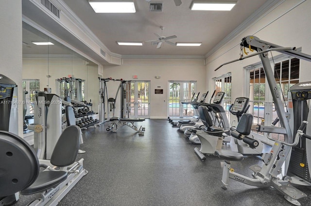 exercise room featuring ornamental molding, a wealth of natural light, a ceiling fan, and visible vents