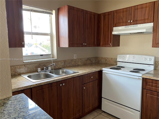 kitchen featuring light tile patterned floors, white electric stove, and sink