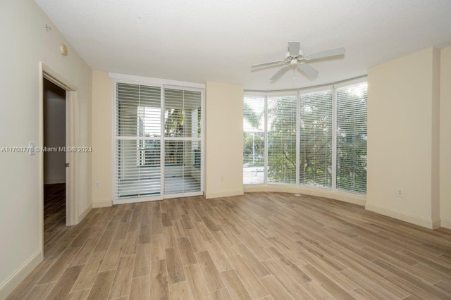 empty room with light hardwood / wood-style flooring and ceiling fan