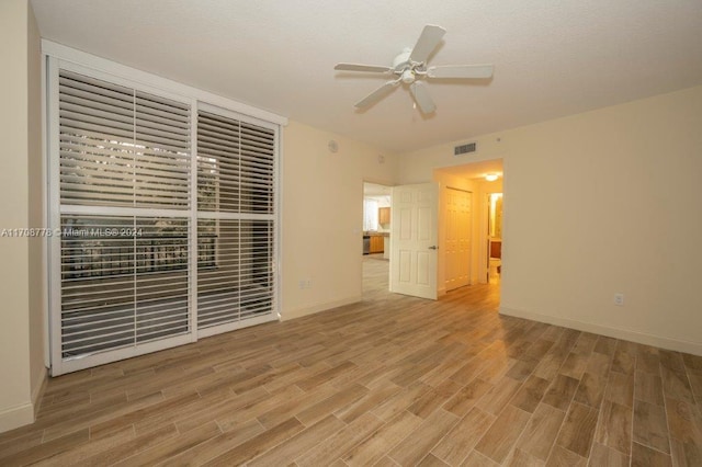 interior space with ceiling fan and wood-type flooring