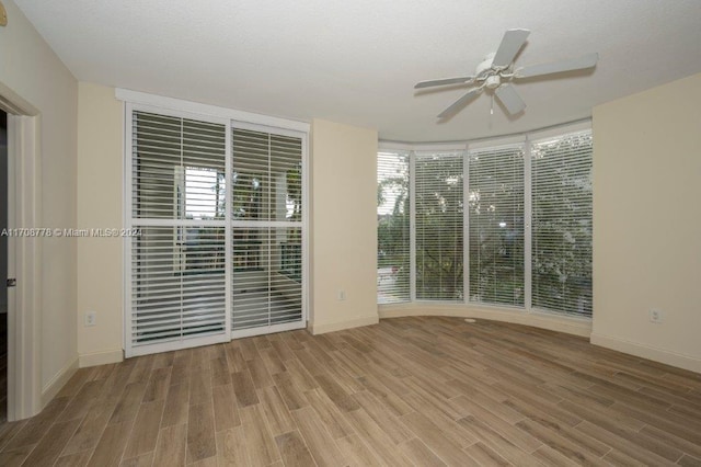 empty room featuring hardwood / wood-style flooring and ceiling fan