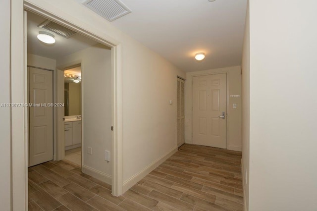 hallway with light hardwood / wood-style flooring