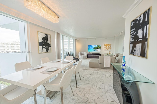 dining area with a textured ceiling, an inviting chandelier, and crown molding