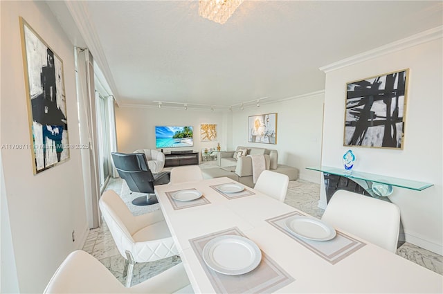 dining space with a textured ceiling, track lighting, and crown molding