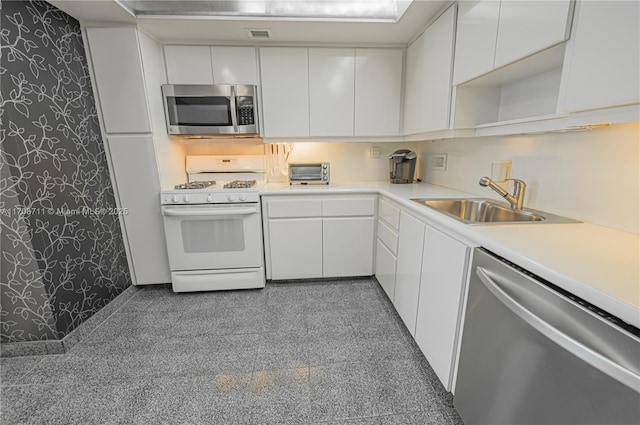 kitchen with white cabinets, sink, and appliances with stainless steel finishes