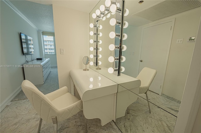 bathroom featuring a textured ceiling and ornamental molding