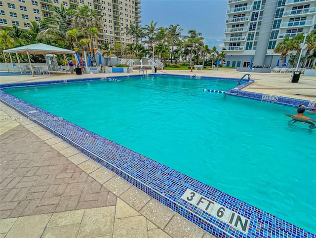 view of pool featuring a gazebo and a patio