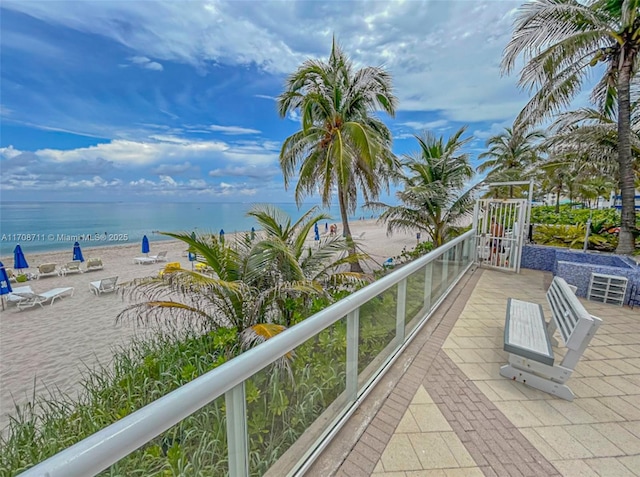 view of patio with a view of the beach and a water view