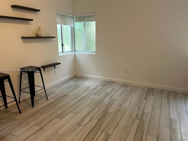 spare room with light hardwood / wood-style flooring