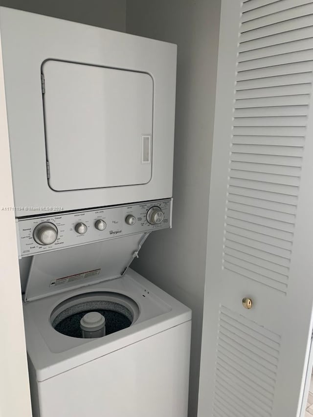 laundry room with stacked washing maching and dryer