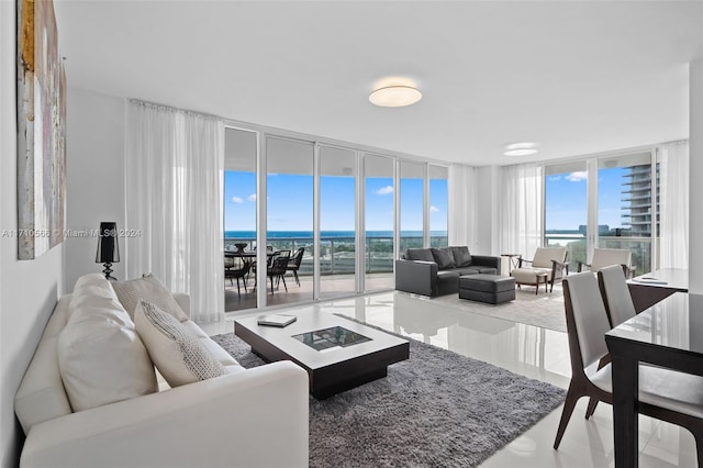 tiled living room with a water view and a wall of windows