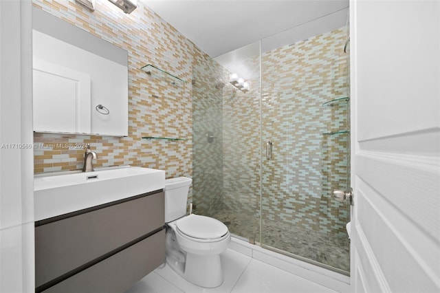 bathroom featuring vanity, backsplash, tile patterned floors, tile walls, and a shower with shower door