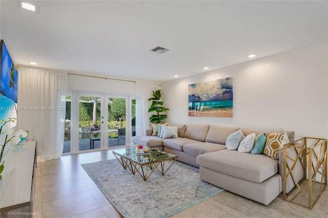 living room featuring french doors and light tile patterned floors