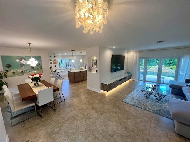 living room with french doors and an inviting chandelier