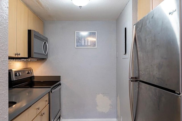 kitchen featuring appliances with stainless steel finishes and light brown cabinets