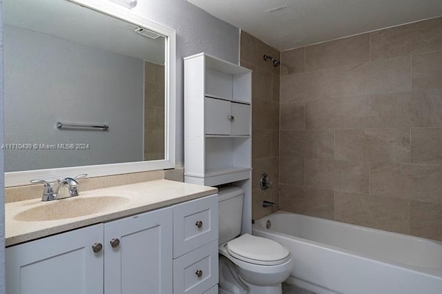 full bathroom featuring tiled shower / bath combo, vanity, and toilet