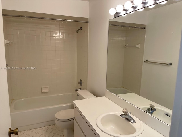 full bathroom featuring tile patterned flooring, vanity, toilet, and tiled shower / bath