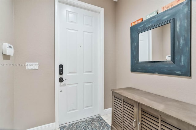 foyer featuring light tile patterned flooring