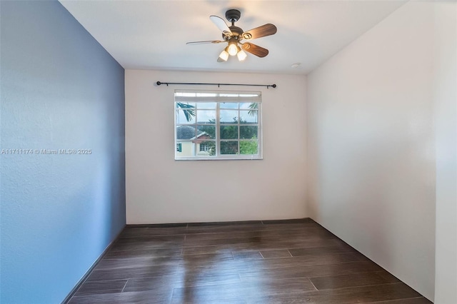 spare room with ceiling fan and dark hardwood / wood-style flooring