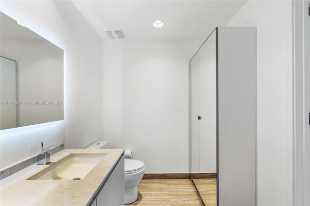 bathroom featuring vanity and toilet