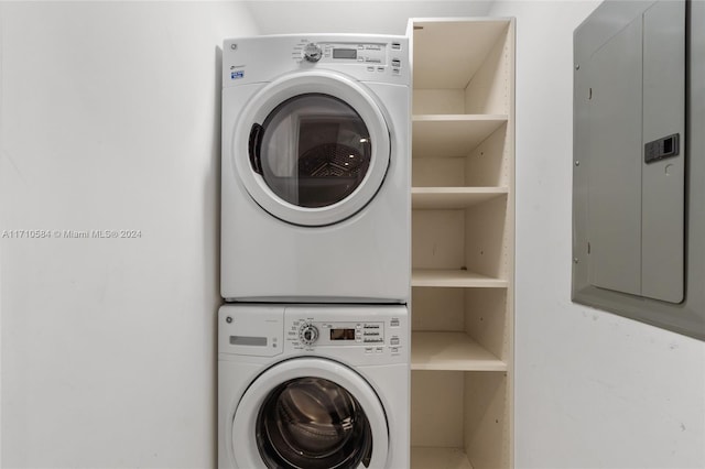 washroom featuring stacked washer / dryer and electric panel