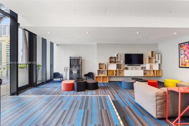 living room featuring carpet flooring and expansive windows