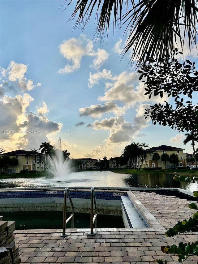 pool at dusk with a water view