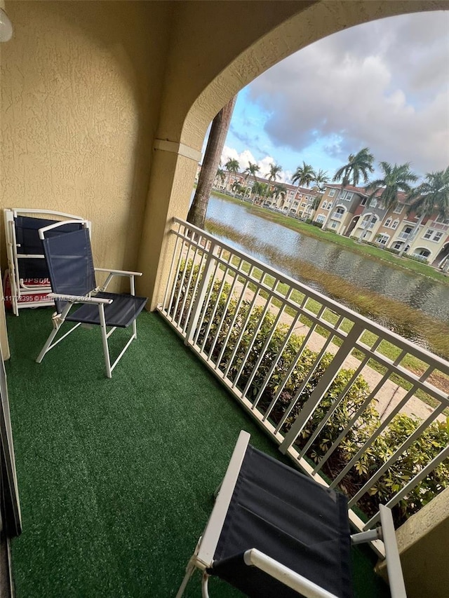 balcony featuring a water view