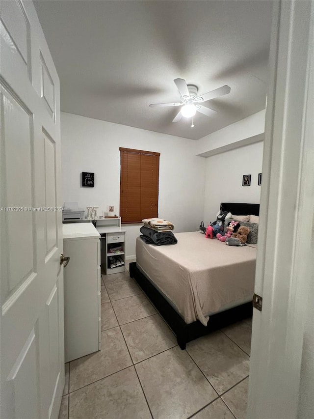 tiled bedroom with ceiling fan