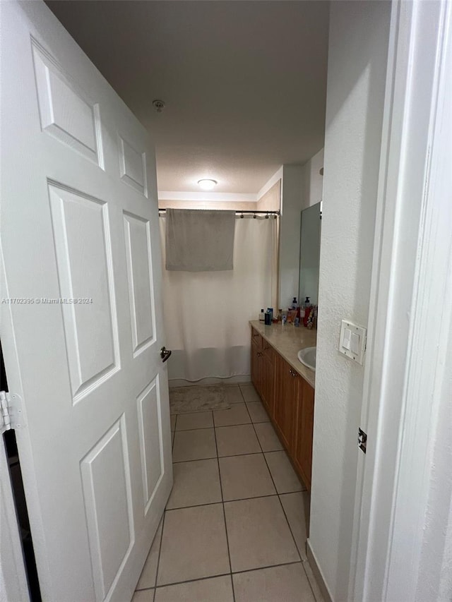 bathroom with vanity, tile patterned floors, and curtained shower