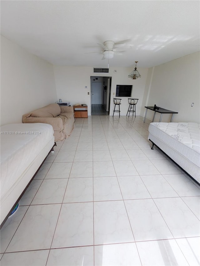 unfurnished living room featuring ceiling fan with notable chandelier