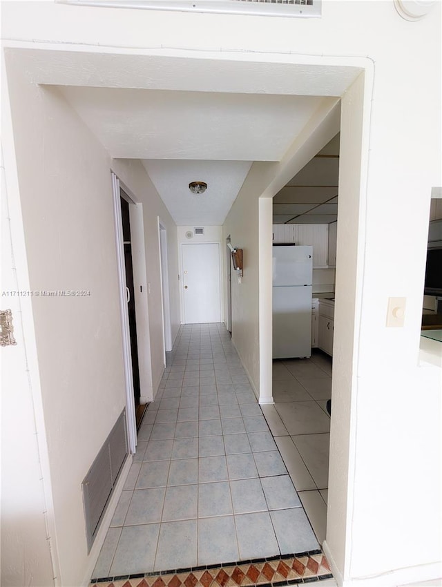 corridor with light tile patterned floors