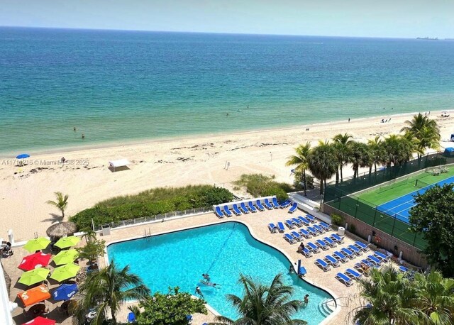 aerial view with a water view and a beach view